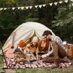 family enjoying board game on camping