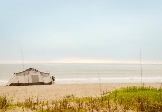beautiful tent setup on beach for camping