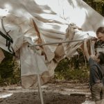 family setting up a canvas tent - family camping tent