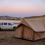 canvas tent setup near the lake