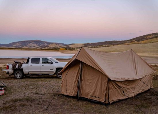 canvas tent setup near the lake
