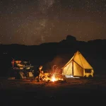 man enjoying campfire during camping under the shining stars