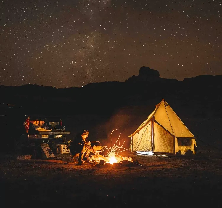 man enjoying campfire during camping under the shining stars
