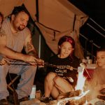 family enjoying campfire on camping