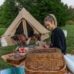 women enjoying evening snacks in camping