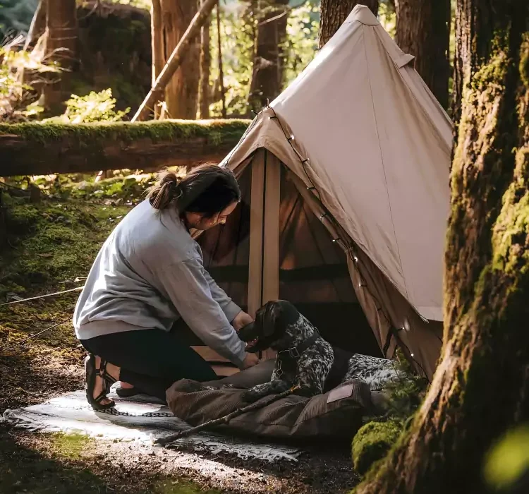 women enjoying outdoors - camping with dog