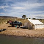 wall tent for hunting near the lake - hunting adventure