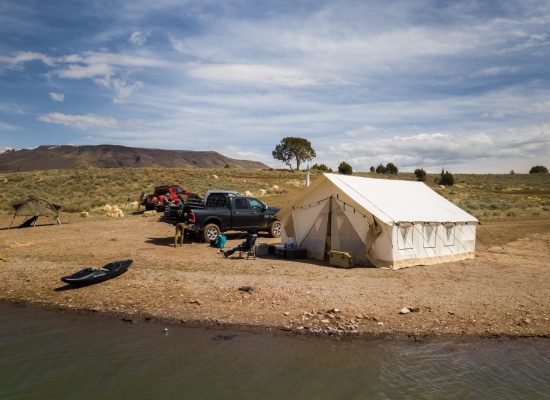 wall tent for hunting near the lake - hunting adventure