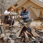 couple enjoying outdoors with campfire