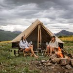friends enjoying camping with amazing view