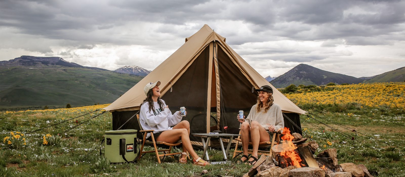 friends enjoying camping with amazing view