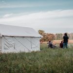 friends enjoying camping with canvas wall tent