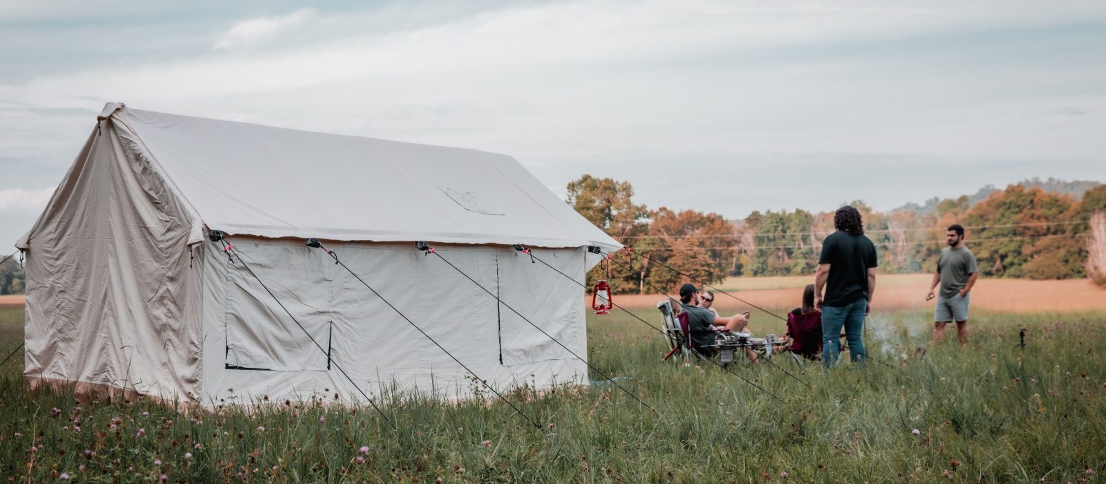 friends enjoying camping with canvas wall tent