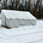 canvas tent setup in a snow