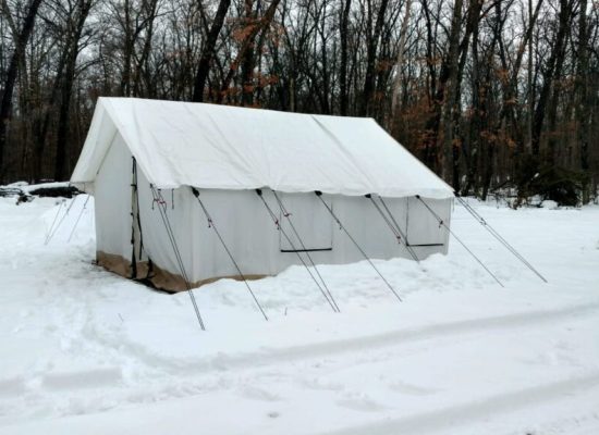 canvas tent setup in a snow