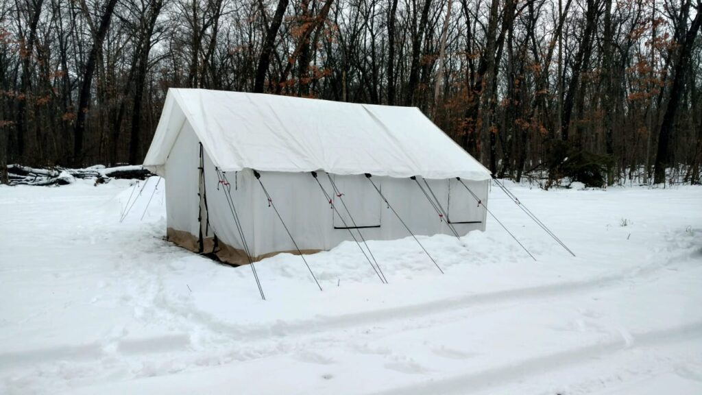canvas tent setup in a snow