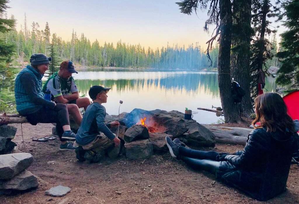 family enjoying camping near the lake