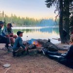family enjoying camping near the lake