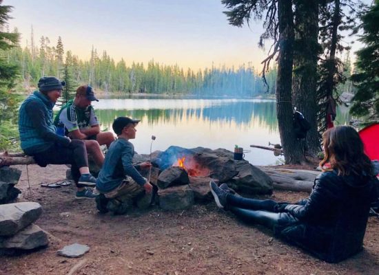 family enjoying camping near the lake