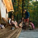 family enjoying camping with a wall tent