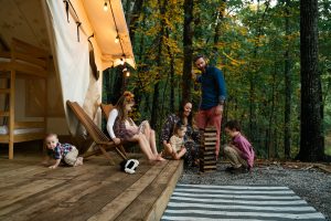 family enjoying camping with a wall tent