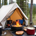 cooking ona tent stove while camping in the nature