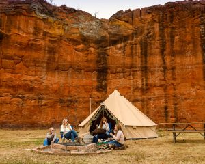women on outdoor adventure with cabin tent