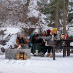 family enjoying camping in snow
