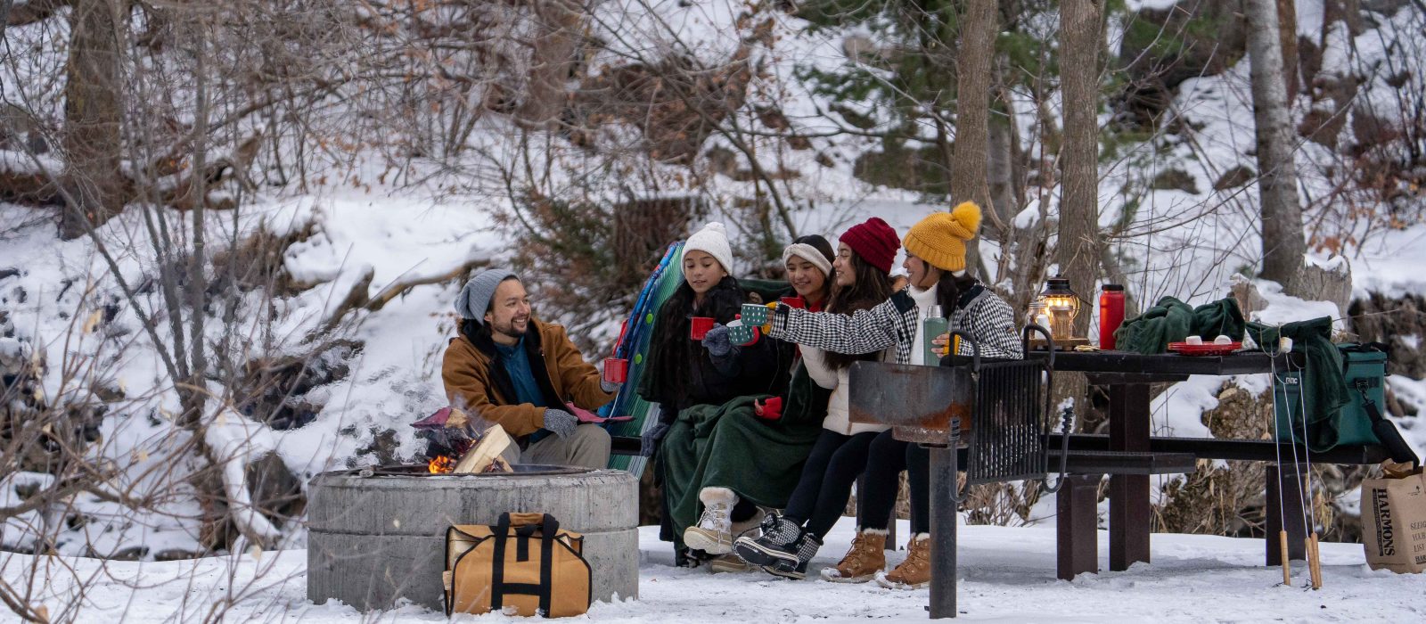 family enjoying camping in snow