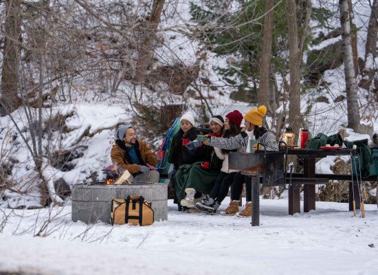 family enjoying camping in snow