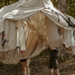 family setting up a tent for family camping