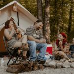 family enjoying meal on camping