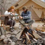couple enjoying coffee on their outdoor adventure