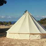 canvas tent setup on beach for camping