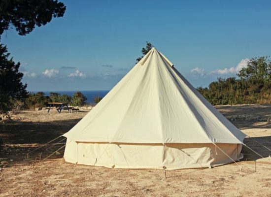 canvas tent setup on beach for camping