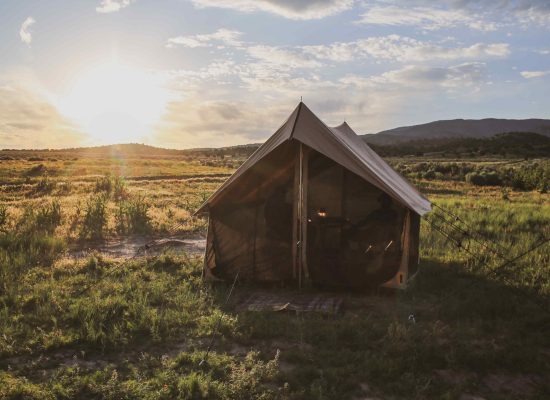 beautiful canvas tent setup in plains for camping
