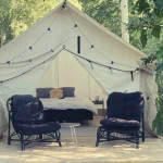 beautiful wall tent with stove jack setup for luxury camping