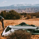 repairing tent screen of bell tent on camping