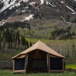 bell tent setup in plains behind mountains for camping