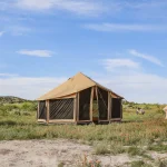 canvas and modern tent setup in the plains for camping