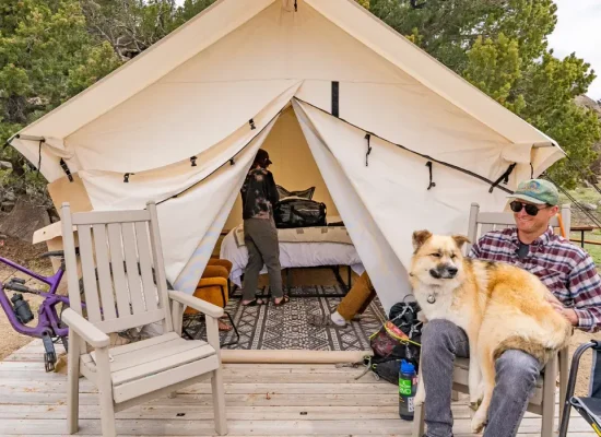 couple enjoying canvas tent camping with dog