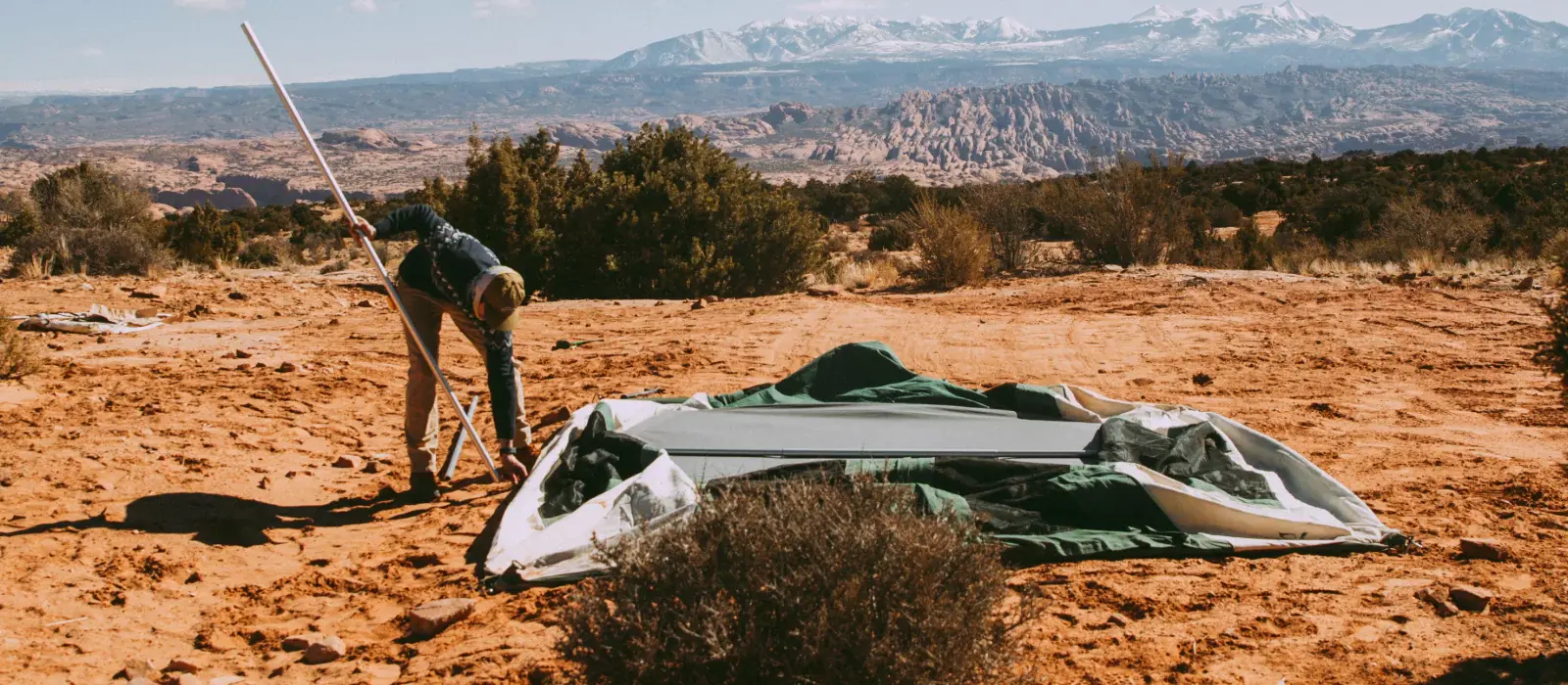 man repairing canvas tent