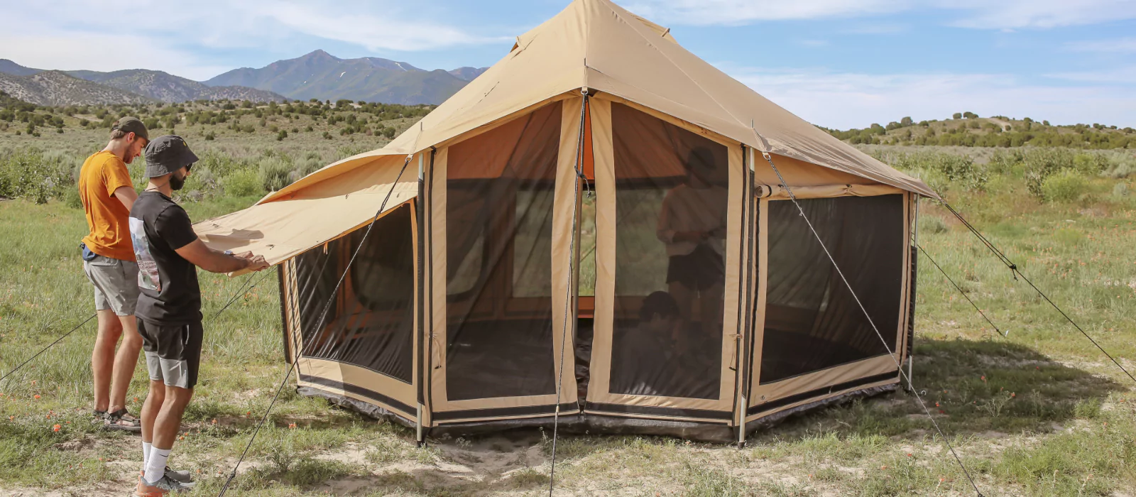 boys maintaining their 4 season tent for camping in plains