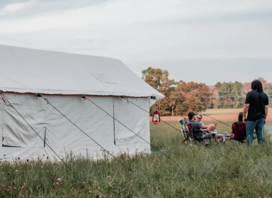 friends enjoying camping in summer with wall tent