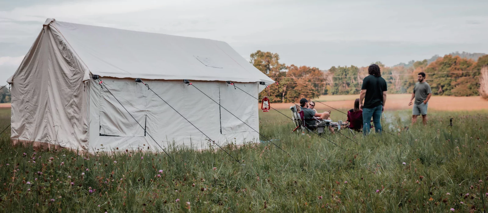 family and friends enjoying outdoors with family camping tent in plains