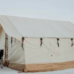 four season wall tent setup in snow for camping