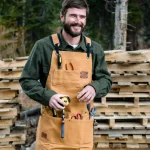 man working in outdoors with canvas working apron