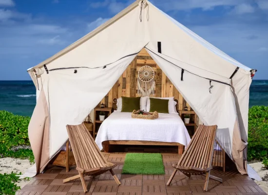 wall tent setup with bed for sleeping near the beach