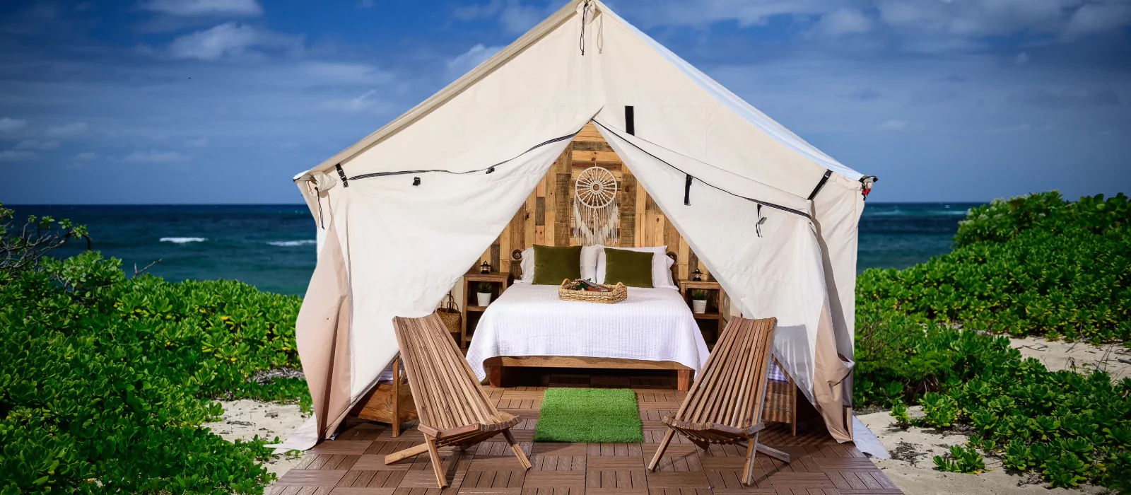 wall tent setup with bed for sleeping near the beach