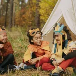 children enjoying halloween camping party and wearing costumes